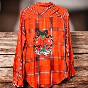 Women’s red plaid button up flannel top with cherry skull graphic